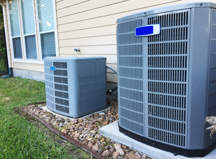 two hvac units outside house